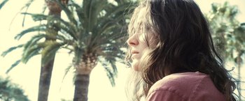 Movie still from “Rust and Bone” (2012), directed by Jacques Audiard – A woman with long brown hair looking to her left; Close Up shot, Low angle