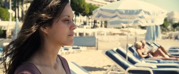 Movie still from “Rust and Bone” (2012), directed by Jacques Audiard – A woman sitting on a chair on the beach; Close Up shot, Over the shoulder angle