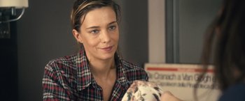 Movie still from “Rust and Bone” (2012), directed by Jacques Audiard – A woman in a plaid shirt is looking at the camera; Close Up shot, Over the shoulder angle