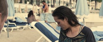 Movie still from “Rust and Bone” (2012), directed by Jacques Audiard – A woman sitting on a chair on the beach; Medium shot, Over the shoulder angle