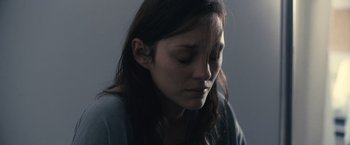 Movie still from “Rust and Bone” (2012), directed by Jacques Audiard – A woman with her eyes closed with her head down; Close Up shot, High angle