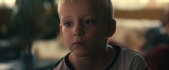 Movie still from “Rust and Bone” (2012), directed by Jacques Audiard – A young boy's face looking at the camera; Close Up shot, High angle
