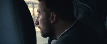 Movie still from “Rust and Bone” (2012), directed by Jacques Audiard – A person sitting in a car; Close Up shot, Over the shoulder angle