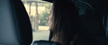 Movie still from “Rust and Bone” (2012), directed by Jacques Audiard – A woman sitting in the back of a car looking out the window; Close Up shot, Over the shoulder angle