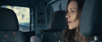 Movie still from “Rust and Bone” (2012), directed by Jacques Audiard – A woman sitting in a car looking out the window; Close Up shot, Over the shoulder angle