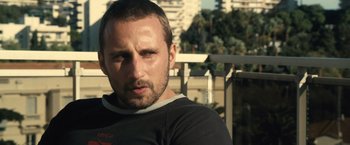 Movie still from “Rust and Bone” (2012), directed by Jacques Audiard – A person wearing a black t - shirt; Close Up shot, Low angle