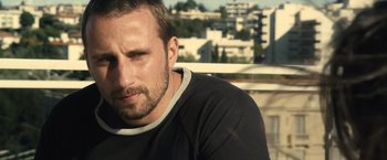 Movie still from “Rust and Bone” (2012), directed by Jacques Audiard – A person wearing a black shirt; Close Up shot, Low angle