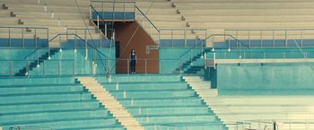 Movie still from “Rust and Bone” (2012), directed by Jacques Audiard – A person standing on a set of stairs; Extreme Wide shot, High angle
