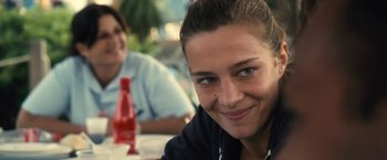 Movie still from “Rust and Bone” (2012), directed by Jacques Audiard – A person sitting at a table; Close Up shot, Over the shoulder angle