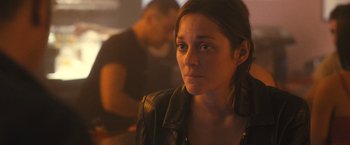 Movie still from “Rust and Bone” (2012), directed by Jacques Audiard – A young woman is looking at the camera; Close Up shot, Over the shoulder angle