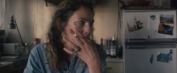 Movie still from “Rust and Bone” (2012), directed by Jacques Audiard – A woman sitting in front of a mirror with her hand on her face; Close Up shot, Over the shoulder angle