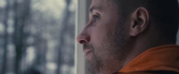Movie still from “Rust and Bone” (2012), directed by Jacques Audiard – A person looking out of a window; Extreme Close Up shot, Low angle