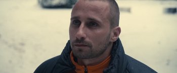 Movie still from “Rust and Bone” (2012), directed by Jacques Audiard – A person wearing a jacket; Close Up shot, Over the shoulder angle