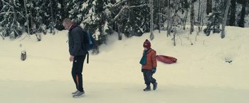 Movie still from “Rust and Bone” (2012), directed by Jacques Audiard – A man and a child walking through the snow; Wide shot, Low angle