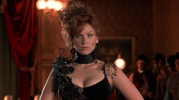 Movie still from “Rustlers' Rhapsody” (1985), directed by Hugh Wilson – A woman with red hair wearing a black dress; Close Up shot, Low angle