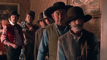 Movie still from “Rustlers' Rhapsody” (1985), directed by Hugh Wilson – A group of men and women wearing hats and vests; Medium shot, Low angle