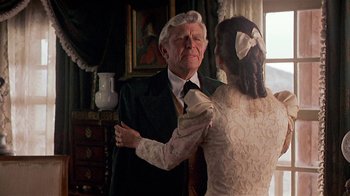 Movie still from “Rustlers' Rhapsody” (1985), directed by Hugh Wilson – An older man and a young woman in a room; Medium shot, Over the shoulder angle