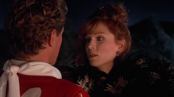 Movie still from “Rustlers' Rhapsody” (1985), directed by Hugh Wilson – A man and a woman looking at one another in the dark; Close Up shot, Over the shoulder angle