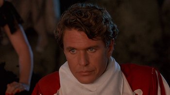 Movie still from “Rustlers' Rhapsody” (1985), directed by Hugh Wilson – A person wearing a red and white shirt; Close Up shot, High angle