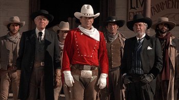 Movie still from “Rustlers' Rhapsody” (1985), directed by Hugh Wilson – A group of men standing next to each other wearing cowboy hats; Medium shot, Low angle