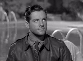 Movie still from “Saboteur” (1942), directed by Alfred Hitchcock – Black and white photograph of a man wearing a leather jacket; Close Up shot, High angle