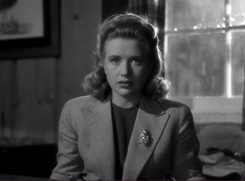 Movie still from “Saboteur” (1942), directed by Alfred Hitchcock – A black - and - white photo of a woman in a suit; Close Up shot, Low angle