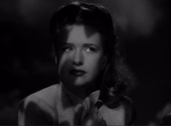 Movie still from “Saboteur” (1942), directed by Alfred Hitchcock – A black - and - white photo of a woman in a suit; Close Up shot, High angle