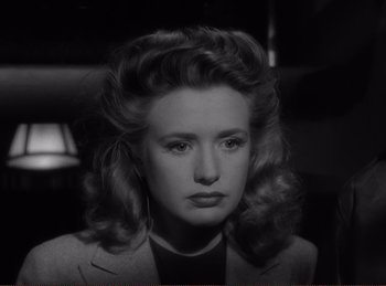 Movie still from “Saboteur” (1942), directed by Alfred Hitchcock – A black and white photo of a woman with a long hair style; Close Up shot, Low angle