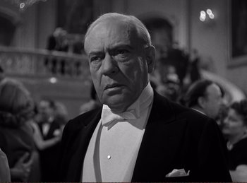 Movie still from “Saboteur” (1942), directed by Alfred Hitchcock – An older man wearing a tuxedo in front of a crowd of onlookers; Close Up shot, Low angle