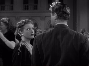 Movie still from “Saboteur” (1942), directed by Alfred Hitchcock – A man and a woman are standing in front of each other; Close Up shot, Over the shoulder angle