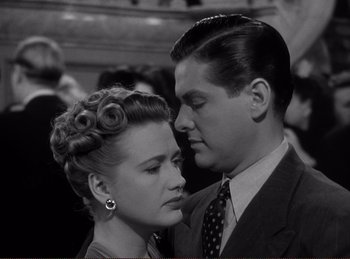 Movie still from “Saboteur” (1942), directed by Alfred Hitchcock – A man and a woman are looking into each others eyes; Close Up shot, High angle