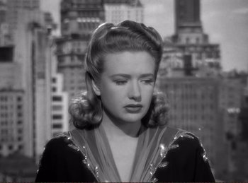 Movie still from “Saboteur” (1942), directed by Alfred Hitchcock – A black and white photo of a woman in a city; Close Up shot, High angle