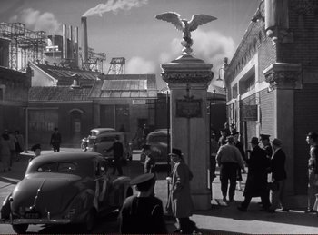 Movie still from “Saboteur” (1942), directed by Alfred Hitchcock – A black and white photo of a street scene; Extreme Wide shot, High angle