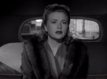 Movie still from “Saboteur” (1942), directed by Alfred Hitchcock – A black and white photo of a woman in a car; Close Up shot, High angle