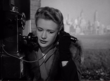 Movie still from “Saboteur” (1942), directed by Alfred Hitchcock – An old photo of a woman talking on a phone; Close Up shot, Low angle