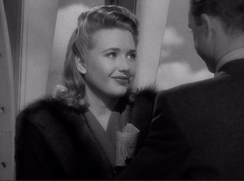 Movie still from “Saboteur” (1942), directed by Alfred Hitchcock – An old photo of a woman with a cup in her hand; Close Up shot, Over the shoulder angle