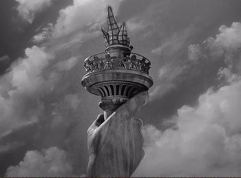 Movie still from “Saboteur” (1942), directed by Alfred Hitchcock – The statue of liberty has a crown on it's head; Extreme Close Up shot, Low angle