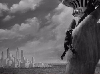 Movie still from “Saboteur” (1942), directed by Alfred Hitchcock – A man is climbing up the side of a building; Extreme Wide shot, Low angle