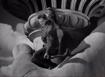Movie still from “Saboteur” (1942), directed by Alfred Hitchcock – A black and white photo of a man on a skateboard; Wide shot, Overhead angle