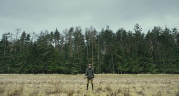 Movie still from “Safari” (2016), directed by Ulrich Seidl – A man standing in the middle of an open field; Extreme Wide shot, Low angle