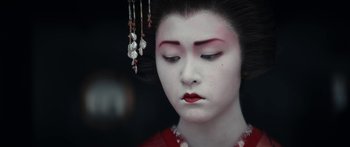 Movie still from “1899” (2022), created by Jantje Friese – A geisha girl with red lipstick and a long black wig; Close Up shot, High angle