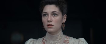 Movie still from “1899” (2022), created by Jantje Friese – A person wearing a dress; Close Up shot, Low angle