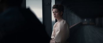 Movie still from “1899” (2022), created by Jantje Friese – A woman in a white dress is looking out a window; Medium shot, Low angle