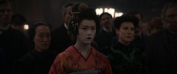 Movie still from “1899” (2022), created by Jantje Friese – A geisha girl in a red and orange kimono; Close Up shot, Over the shoulder angle