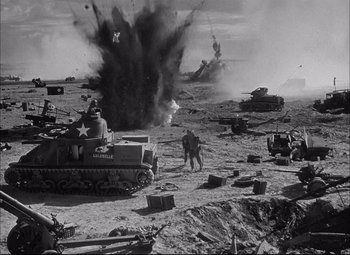 Movie still from “Sahara” (1943), directed by Zoltan Korda – An image of a war scene in black and white; Extreme Wide shot, High angle