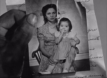 Movie still from “Sahara” (1943), directed by Zoltan Korda – An old photo of a woman holding a child; Extreme Close Up shot, High angle