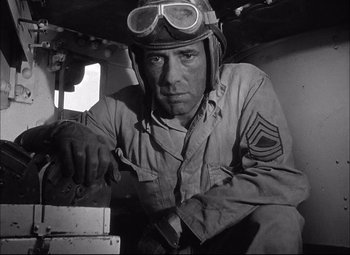 Movie still from “Sahara” (1943), directed by Zoltan Korda – An old photo of a man wearing a helmet and goggles; Medium shot, Low angle