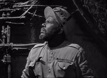Movie still from “Sahara” (1943), directed by Zoltan Korda – A black and white photo of a man wearing a hat; Close Up shot, Low angle
