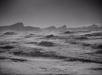 Movie still from “Sahara” (1943), directed by Zoltan Korda – A black - and - white photo of a large body of water; Extreme Wide shot, High angle