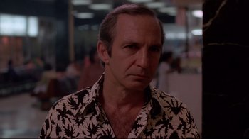 Movie still from “Saint Jack” (1979), directed by Peter Bogdanovich – A person wearing a hawaiian shirt; Close Up shot, Low angle